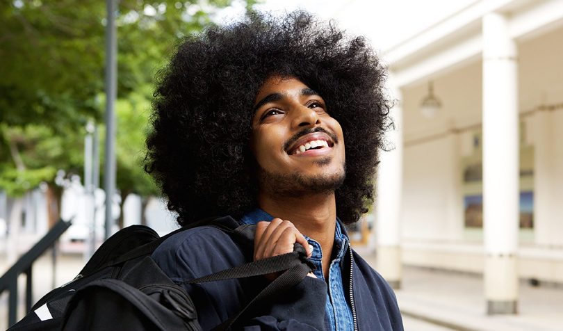 Smiling black student with afro Portrait of a smiling black male student with afro